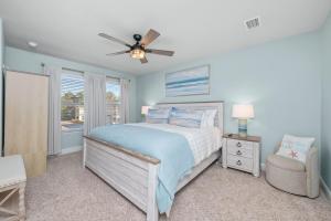 a bedroom with a bed and a ceiling fan at SEA-Bound STR in Pensacola +20 photos