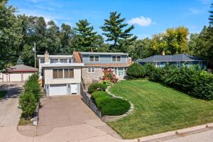 a house with a garden and a driveway at Burban Bungalow in Maplewood