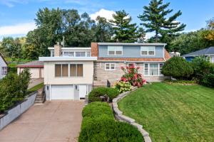 a house with a driveway and a yard at Burban Bungalow in Maplewood