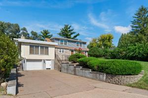 a house with a driveway and a garage at Burban Bungalow in Maplewood +63 photos