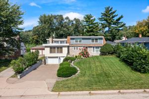an exterior view of a house with a yard at Burban Bungalow in Maplewood
