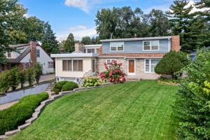 a home with a large yard with green grass at Burban Bungalow in Maplewood