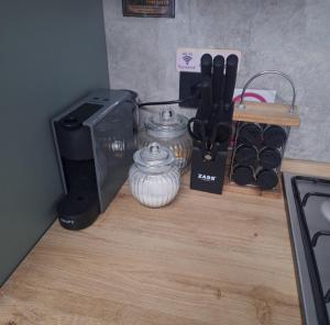 a kitchen counter with a microwave and a toaster and utensils at Cabana Edav in Ţibău