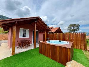 a backyard with a hot tub in the grass at Chalés São Pedro in Socorro