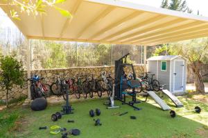 a gym with a group of bikes parked under a pavilion at Golden Sun Villas in Nydri