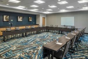 a large room with tables and chairs and a whiteboard at TownePlace Suites by Marriott Canfield in Canfield +17 photos