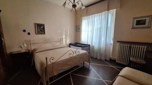 a bedroom with a bed and a window and a couch at Red Horse in Pisa