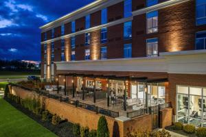 an exterior view of a building with tables and chairs at SpringHill Suites by Marriott Canfield in Canfield