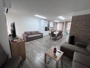 a living room with a couch and a table at Tonzuso Holyday House in Agnone Bagni