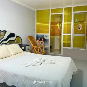 a bedroom with a bed and two people in a bathroom at Yaku Hotel in Cajamarca