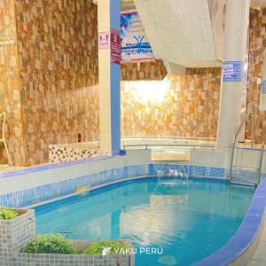 a large swimming pool in a building at Yaku Hotel in Cajamarca