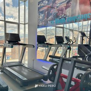 a gym with cardio machines and a large window at Yaku Hotel in Cajamarca