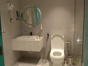 a bathroom with a toilet and a sink and a mirror at فندق الريان Ryan Hotel in Jeddah +16 photos