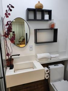 a bathroom with a sink and a mirror at Loft 101 in Rio de Janeiro