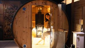 a woman is standing in a wooden room at SAKURA YAKUSHIMA in Yakushima +62 photos