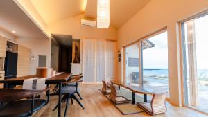 a dining room with a view of the ocean at SAKURA YAKUSHIMA in Yakushima
