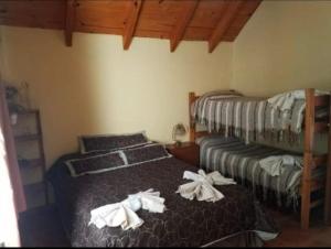 two beds in a room with towels on them at Impecable departamento en radar centrico in Ushuaia