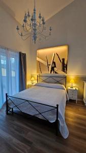 a bedroom with a large bed and a chandelier at Chiantirooms Guesthouse in Greve in Chianti +34 photos