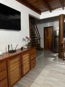 a living room with a large television on the wall at Casa.dovale3 in Caeté-Açu