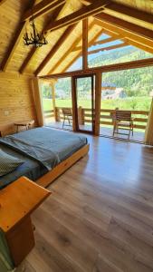 a bedroom with a large bed in a wooden house at Villas Jezerca in Valbonë