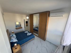 a small bedroom with a bed and a mirror at Marelia in Orikum