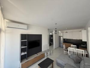 a living room with a couch and a flat screen tv at Marelia in Orikum