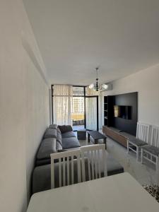 a living room with a couch and a table at Marelia in Orikum