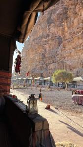 a view of a rocky mountain with a table with a light at Rum Arena camp in Wadi Rum