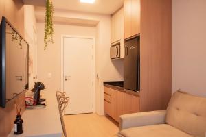 a small living room with a couch and a kitchen at Essential 2U in São Paulo +21 photos