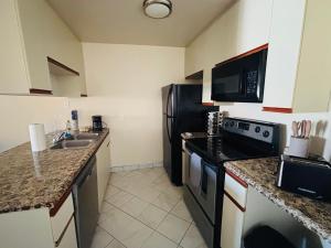 a kitchen with a black refrigerator and a sink at 1Bd Prime Westwood Location One Block from UCLA in Los Angeles +3 photos