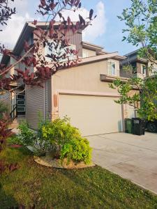 a house with a garage with a bunch of birds on the roof at Modern 4BDRM Home-2 King Bed- Full House in Edmonton
