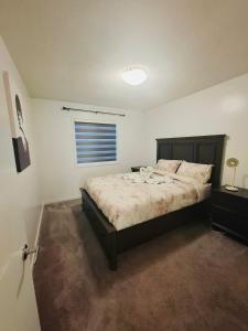 a bedroom with a bed and a window at Modern 4BDRM Home-2 King Bed- Full House in Edmonton