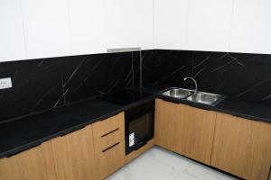 a kitchen with a sink and a counter top at Marelia in Orikum +60 photos
