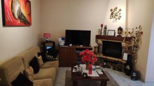 a living room with a couch and a tv at Room 3 - Music House in Conceição