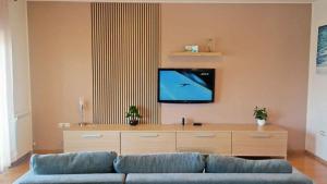 a living room with a couch and a flat screen tv at Apartment in Cavle 54436 in Čavle