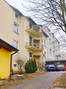 a building with balconies on the side of a street at Magic Place parking, Air Conditioning, Self Check In in Oświęcim