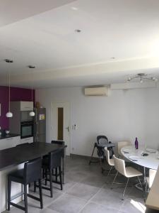 a kitchen and dining room with a table and chairs at Maison village entre pau et lourdes in Boeil-Bezing