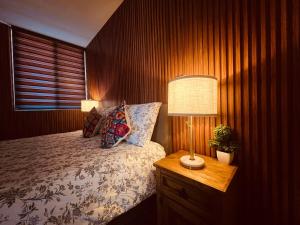 a bedroom with a bed and a lamp on a night stand at Private Patio, Peaceful and Centric in Cedro