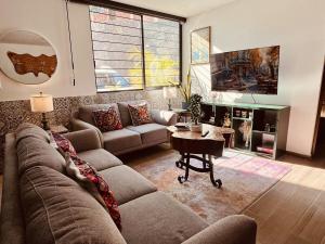 a living room with a couch and a table at Private Patio, Peaceful and Centric in Cedro