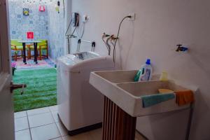 a bathroom with a sink and a washing machine at Private Patio, Peaceful and Centric in Cedro +27 photos