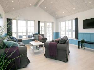 a living room with two couches and a table at 8 person holiday home in Læsø in Læsø
