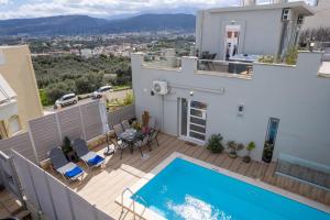 a villa with a swimming pool on a balcony at Vista Magica in Chania