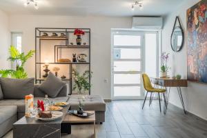 a living room with a couch and a table at Vista Magica in Chania