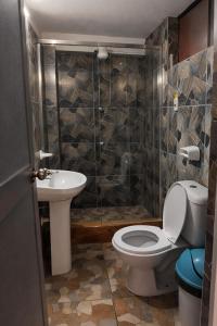 a bathroom with a toilet and a sink at Hospedaje Tikari in Chincheros +30 photos