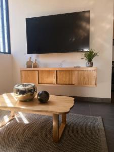 a living room with a tv and a coffee table at Cielo Suites in Oaxaca City