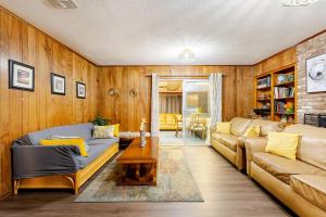 a living room with a couch and a table at Abbies Place in Pine Bluff in Pine Bluff
