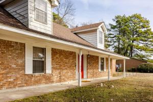 a brick house with a red door at Abbies Place in Pine Bluff in Pine Bluff