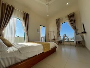 a bedroom with a bed with a view of the ocean at LANBA Homestay in Phan Rang–Tháp Chàm