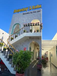 a building with stairs and plants in a courtyard at LANBA Homestay in Phan Rang–Tháp Chàm