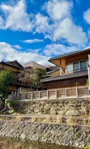a house with a stone staircase in front of a house at Maru Izumiyacho in Kyoto